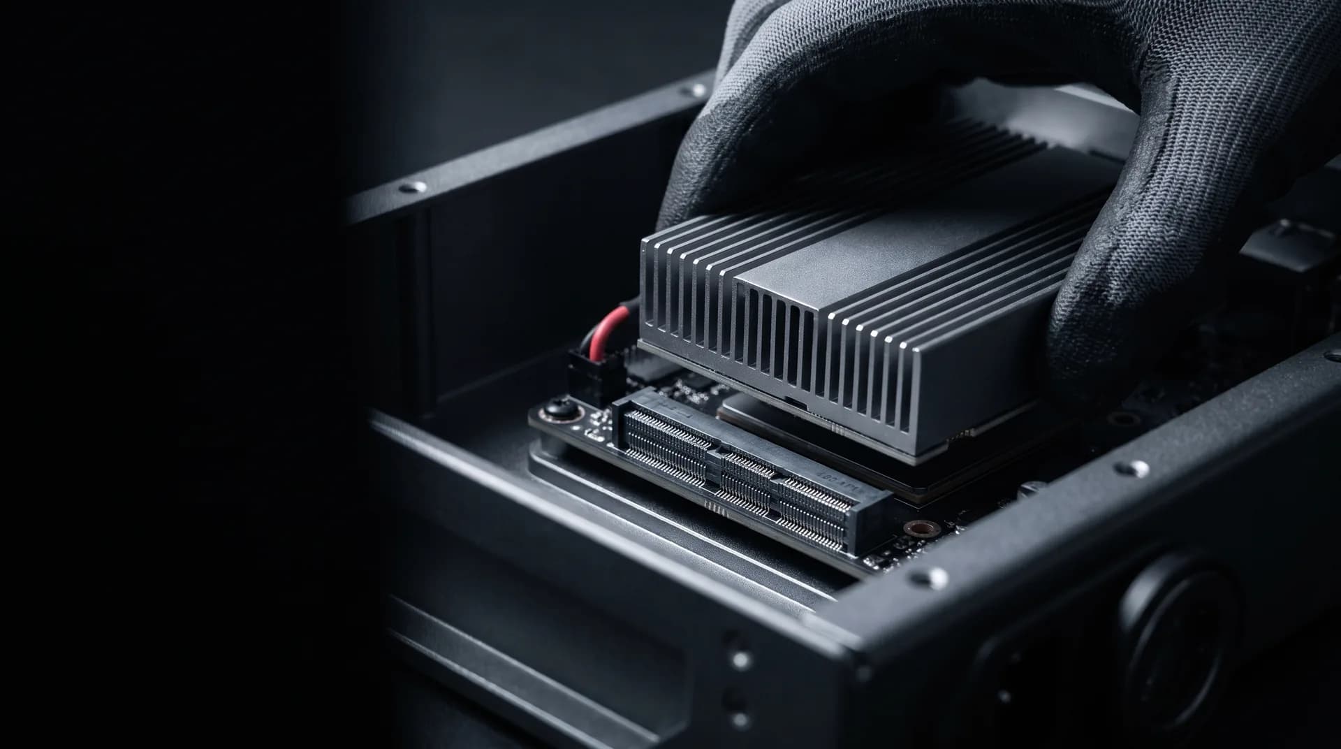 GPU compute module being lowered onto a carrier board inside a rugged enclosure